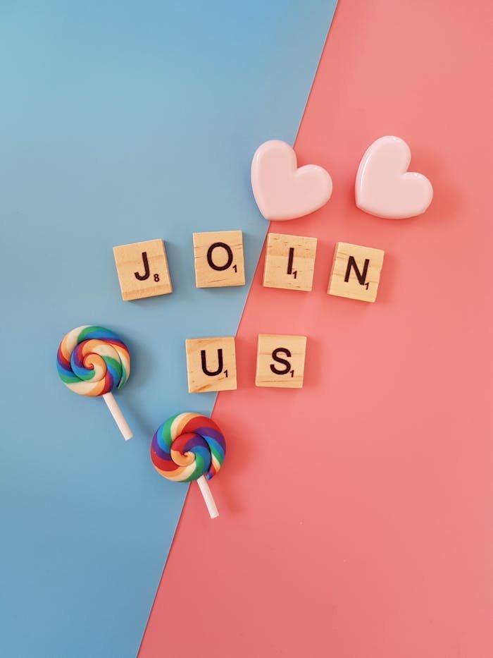 Bright Join Us call-to-action with colorful lollipops and hearts on a pastel background.